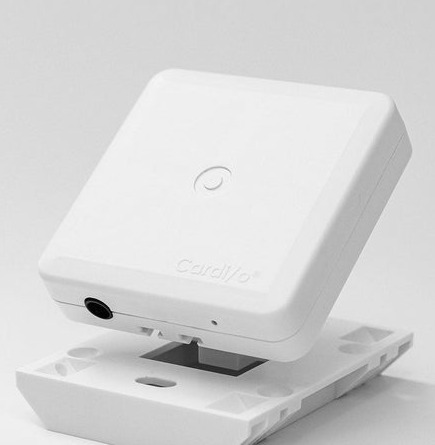 The Cardi/o&reg; sensor, a small white square carrying the Cardi/o wordmark, resting on its bracket